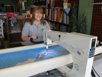 JoBeth Bryant of Crafters Lodge demonstrates the Long Arm Quilting Machine nicknamed, "Millie"